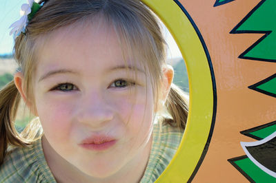 Close-up portrait of cute girl puckering