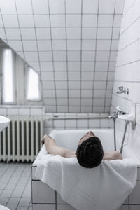 Man resting in bathtub