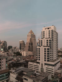Buildings in city against clear sky