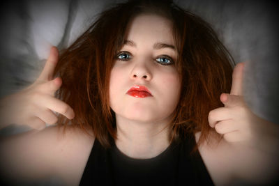 Close-up portrait of confident teenage girl gesturing