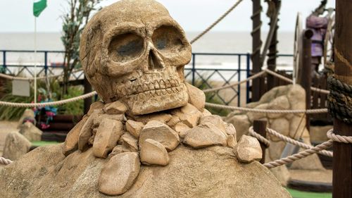 Close-up of skull statue at crazy golf