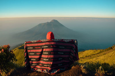 Enjoy the beauty at the top of mount merbabu with a view of mount merapi volcano