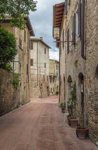 Empty alley amidst buildings in city