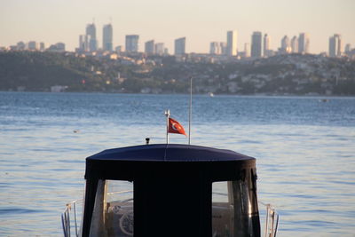 Pier on sea against cityscape