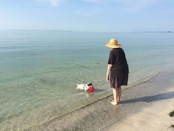 Senior woman with dog at beach