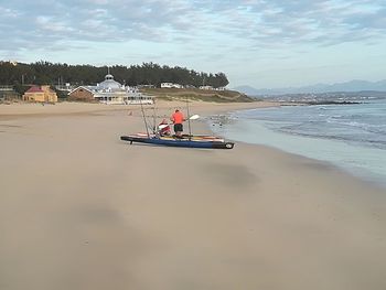 People on beach against sky