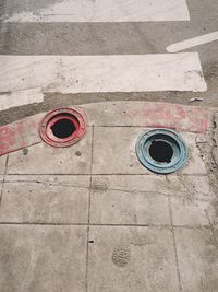 High angle view of holes at sidewalk