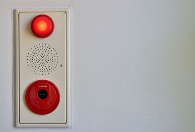 Fire alarm switch and red light on wall