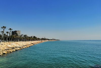 Scenic view of sea against clear blue sky