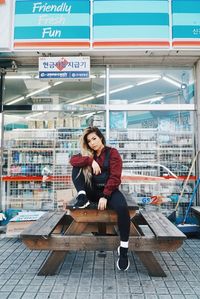 Portrait of young woman sitting on seat