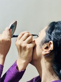 Close-up of women doing eye makeup 
