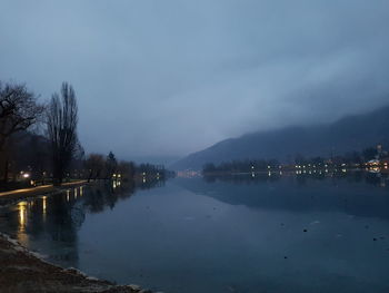 Scenic view of river against sky at night