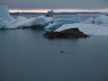 Scenic view of sea against sky during winter