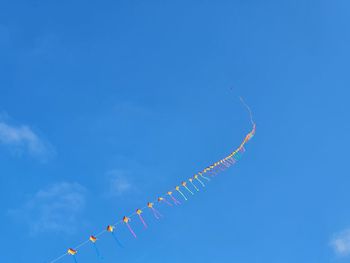 Low angle view of airshow against blue sky