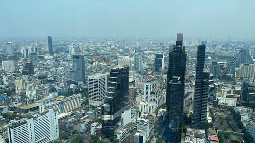 High angle view of modern buildings in city against sky