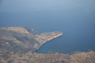 High angle view of sea and mountain against sky