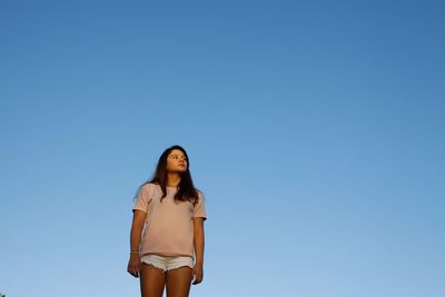Woman standing against clear sky