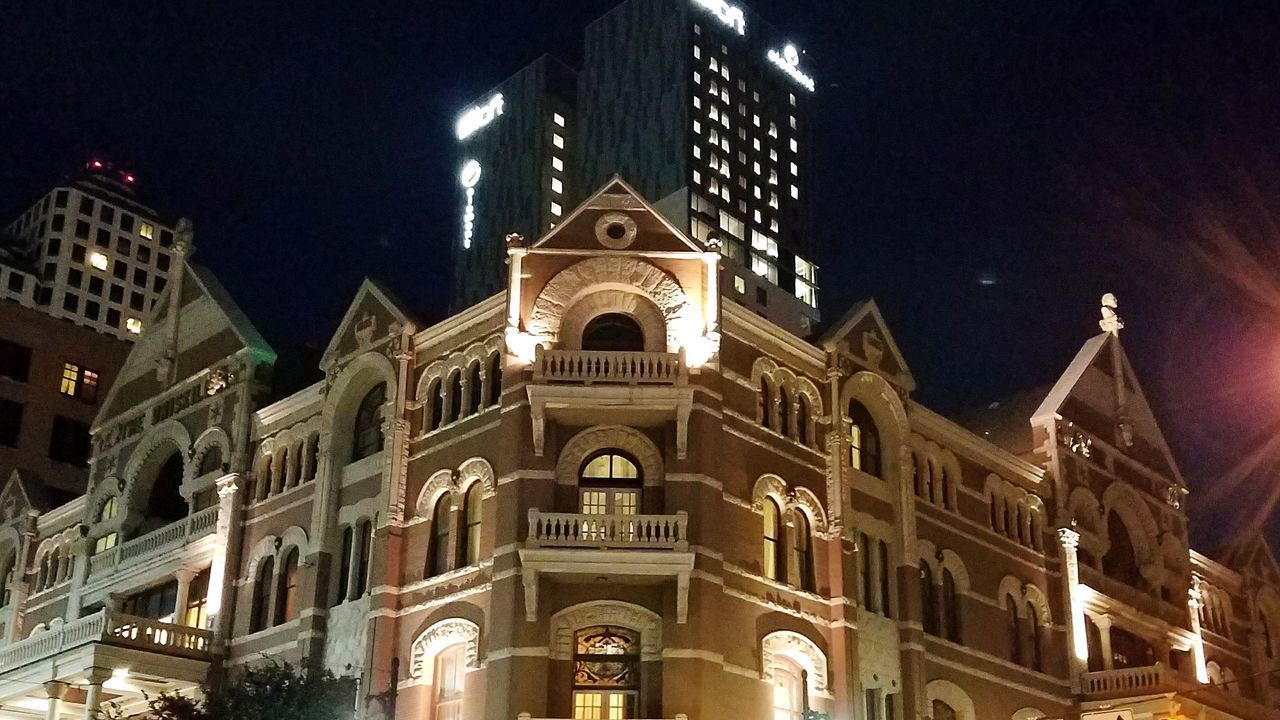 LOW ANGLE VIEW OF ILLUMINATED CATHEDRAL AT NIGHT