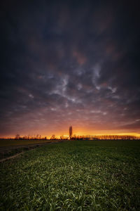 Scenic view of field against sky during sunset