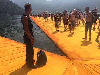 Low section of people walking on pier