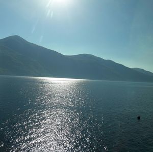 Scenic view of sea and mountains against sky