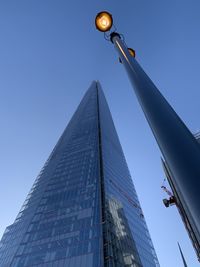 Low angle view of street light against building