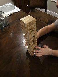 High angle view of woman hand on table