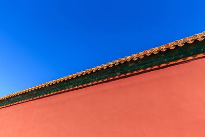 Low angle view of building against clear blue sky