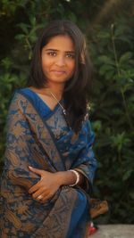 Portrait of smiling young woman standing outdoors