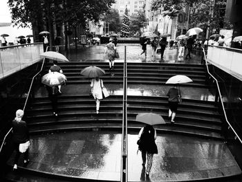 High angle view of people moving up on steps during monsoon