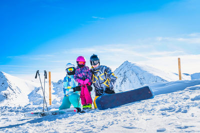 Family on ski and snowboard, winter holidays in andorra, pyrenees mountains