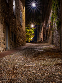 Street amidst buildings in city at night