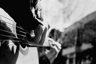 Cropped image of person playing guitar