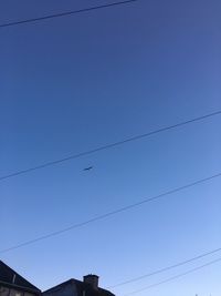 Low angle view of birds flying against sky