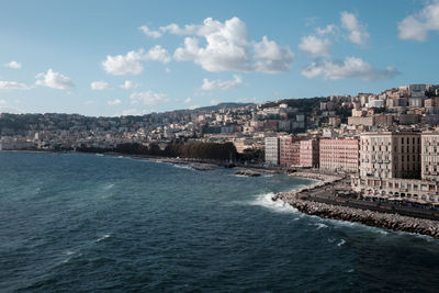 Panoramic view of sea and buildings against sky