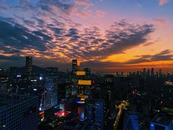 High angle view of illuminated buildings against sky during sunset