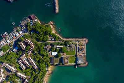 High angle view of city by sea against sky