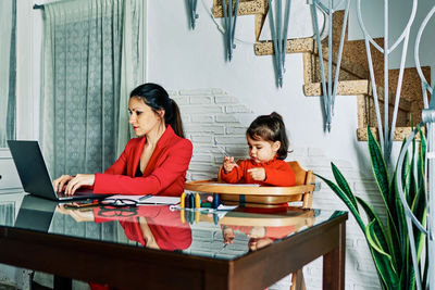 Women sitting on table at home
