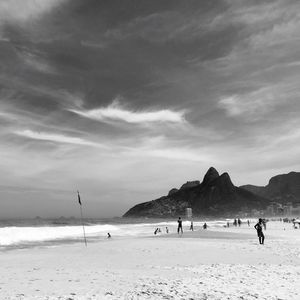 People on beach against sky