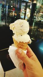 Close-up of hand holding ice cream