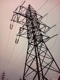 Low angle view of electricity pylon against sky