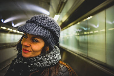 Thoughtful woman looking away at subway station