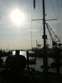 Sailboats in sea at sunset