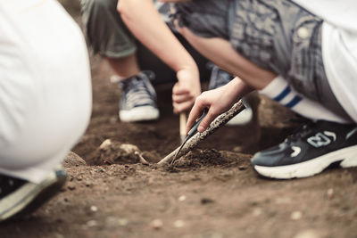 Low section of man tying shoelace
