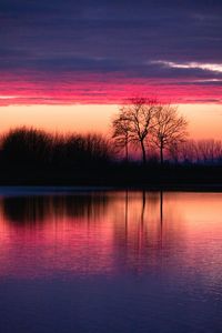 Scenic view of lake against romantic sky at sunset