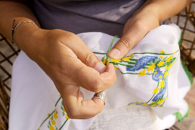 Close-up of woman weaving fabric