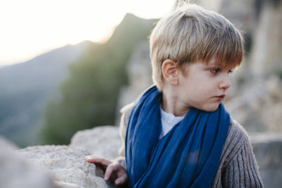 Close-up of boy on rock