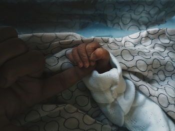 Cropped hands of mother and baby