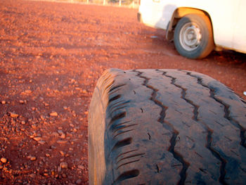 Close-up of tire track on dirt road