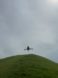 Low angle view of airplane flying against sky